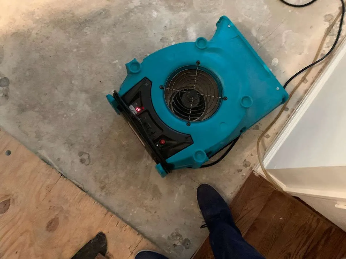 Air mover drying subfloor during Commercial Water Damage Restoration in Independence